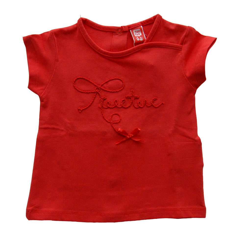 
  T-shirt della linea abbigliamento bambina Tuc Tuc. Modello basico a tinta unita
  con ricamo t...